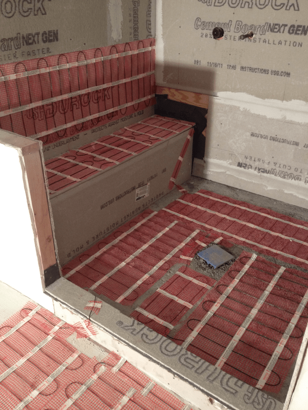 Warmup mat system being installed in a shower